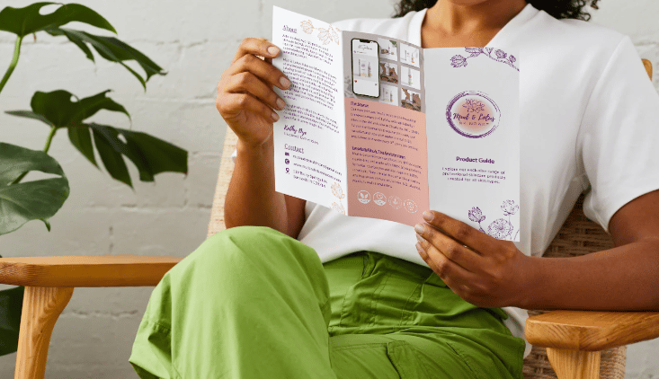 woman holding skincare brochure with mud and lotus natural and organic skincare