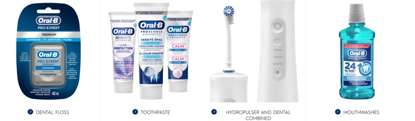a group of Oral B toothbrushes and toothpaste