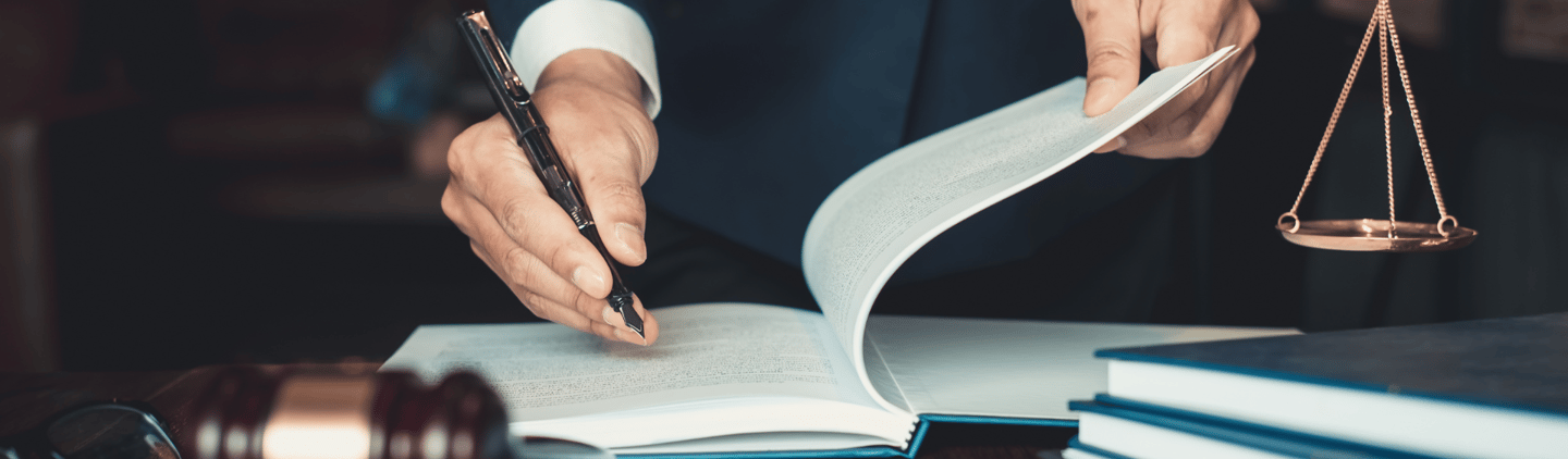 a judge's hand holding a gavel and a gavel