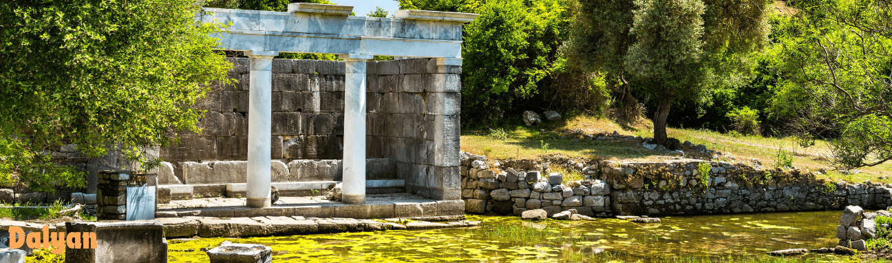 a stone building with a bench in an ancient city