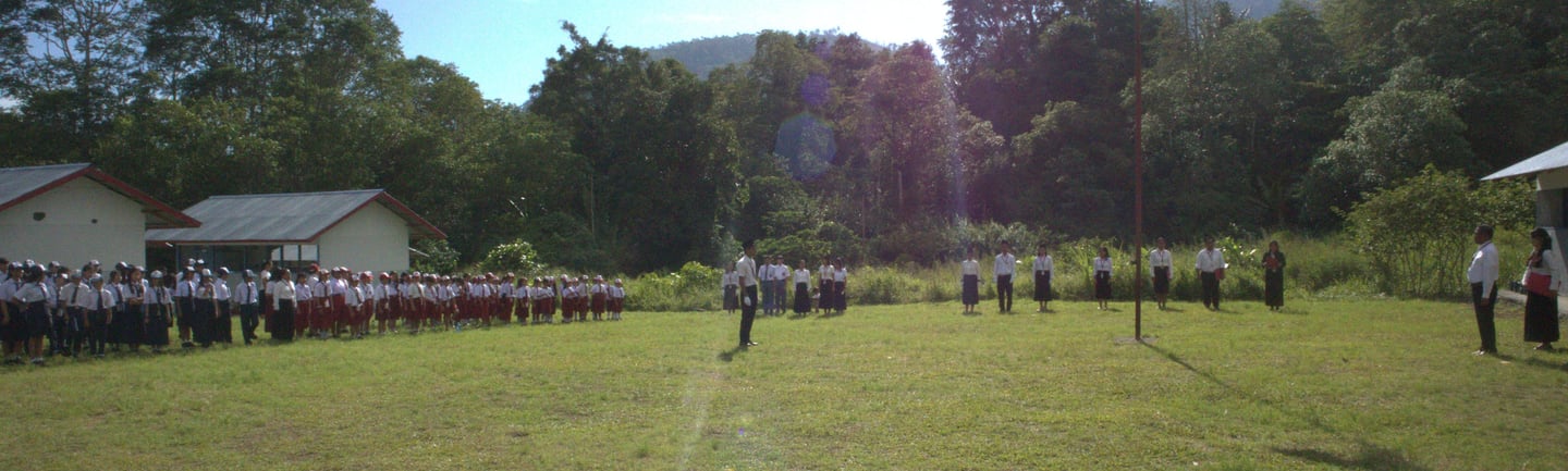 a group of people standing in a field with flag