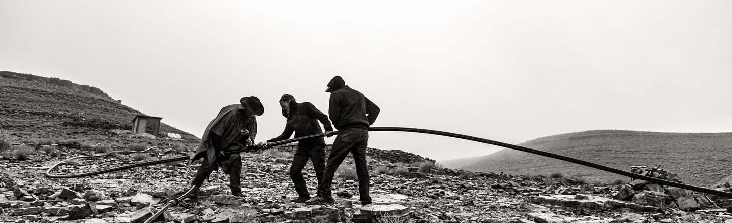 a group of men working on a rocky mountain