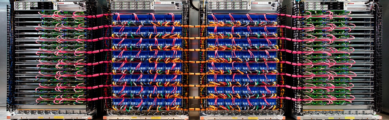 A high-performance data center server rack with organized fiber optic cables and networking hardware.