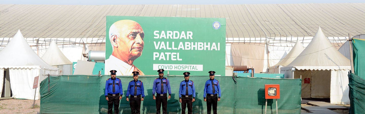 a group of police officers standing in front of a large billboard