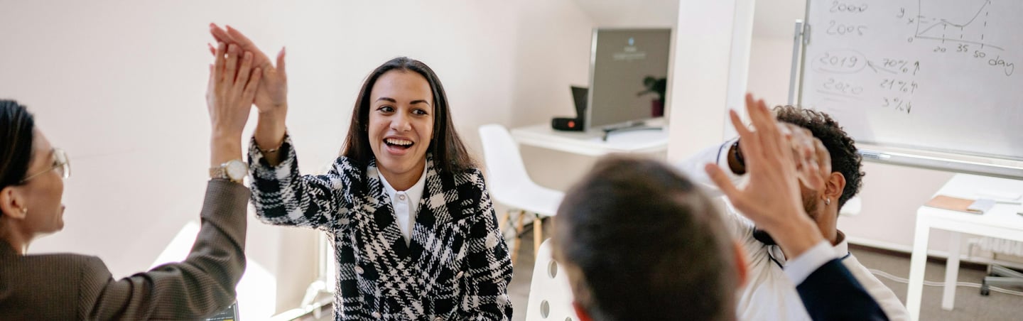 a woman is giving a high five to her team