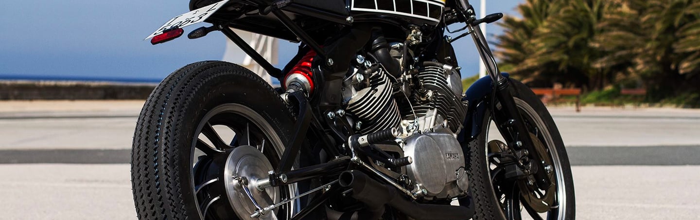 a motorcycle parked on the street in front of a building