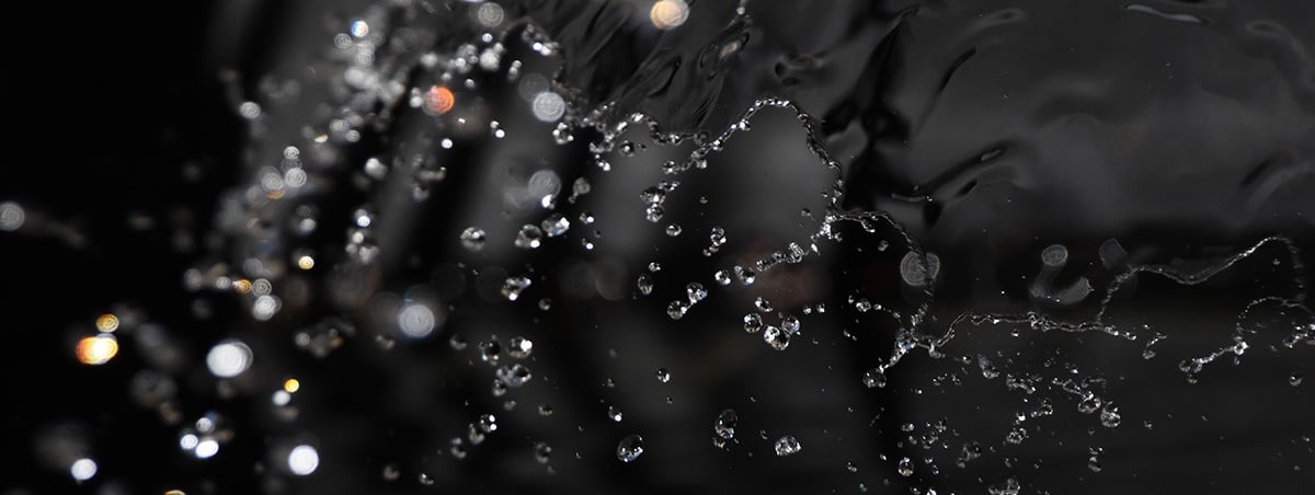 a close up of a water fountain with water droplets