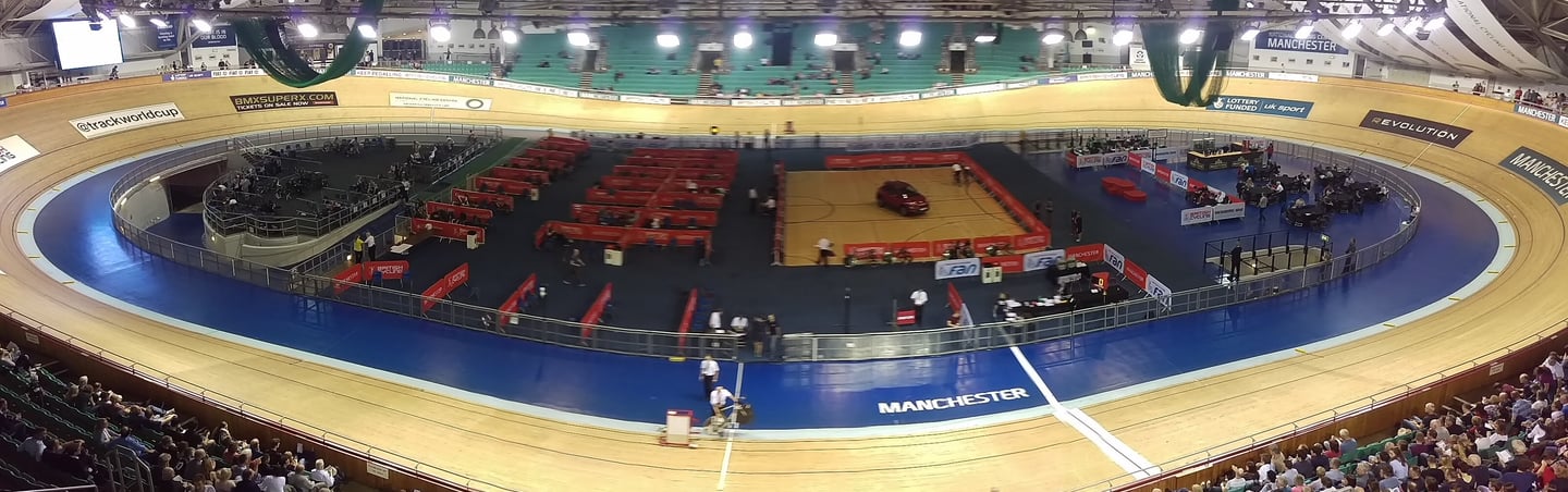 a track cycling track, with track cyclists and crowd
