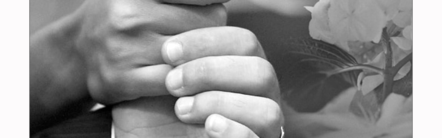 a man and woman holding hands in a black and white photo