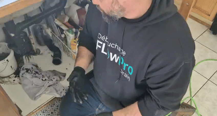 Professional drain cleaning technician operating high-pressure hydro-jet system