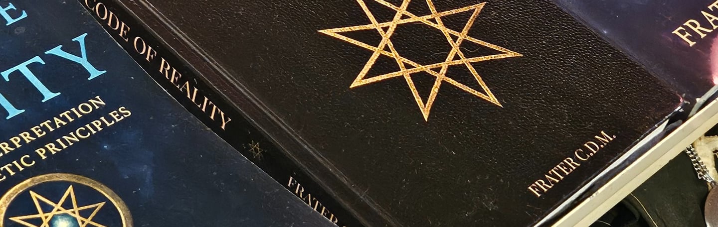 Different versions of "The Code of Reality" aligned on a display.
