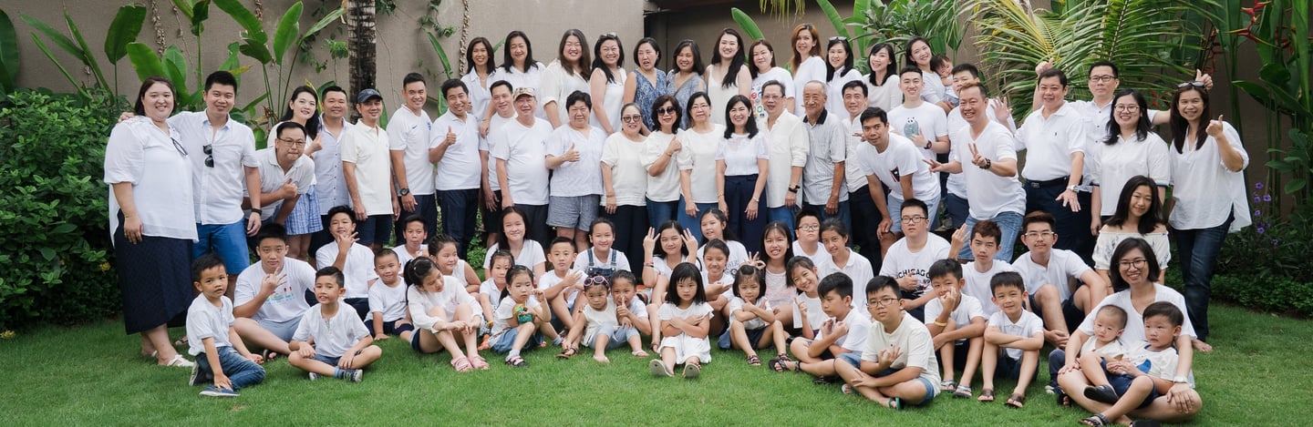 Large extended family group portrait at Lumbini Villas Jimbaran Bali captured in a spacious outdoor setting