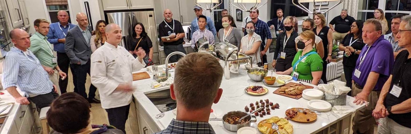 Chef Andrew gives a presentation in a modern home on kitchen appliances.