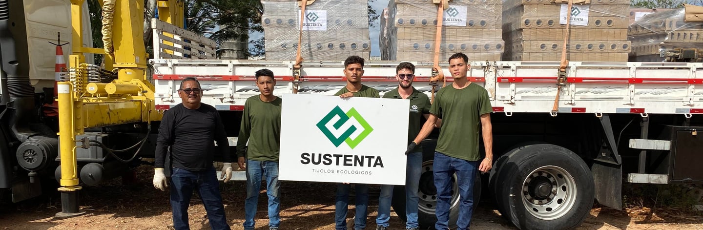 a group of men standing in front of a truck