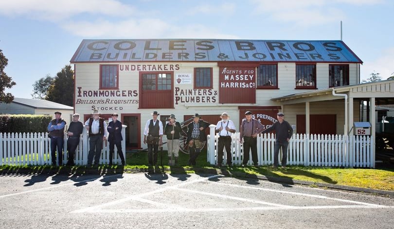 Volunteers in period costume standing in front of the restored Coles Joinery Factory