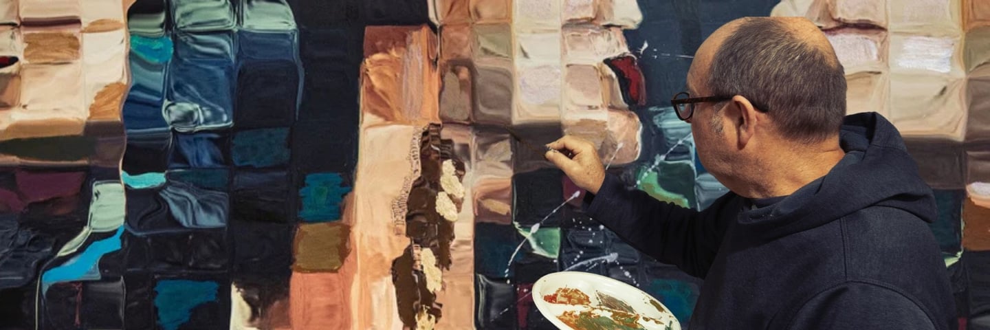 Martin Osner painting a textured mixed media artwork in his studio. He holds a palette of earthy paints an abstract portrait