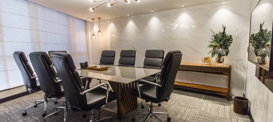 uma sala de conferências com mesa e cadeiras de conferência