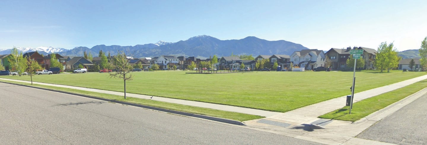 a street scene with a street sign and a car parked on the side of the