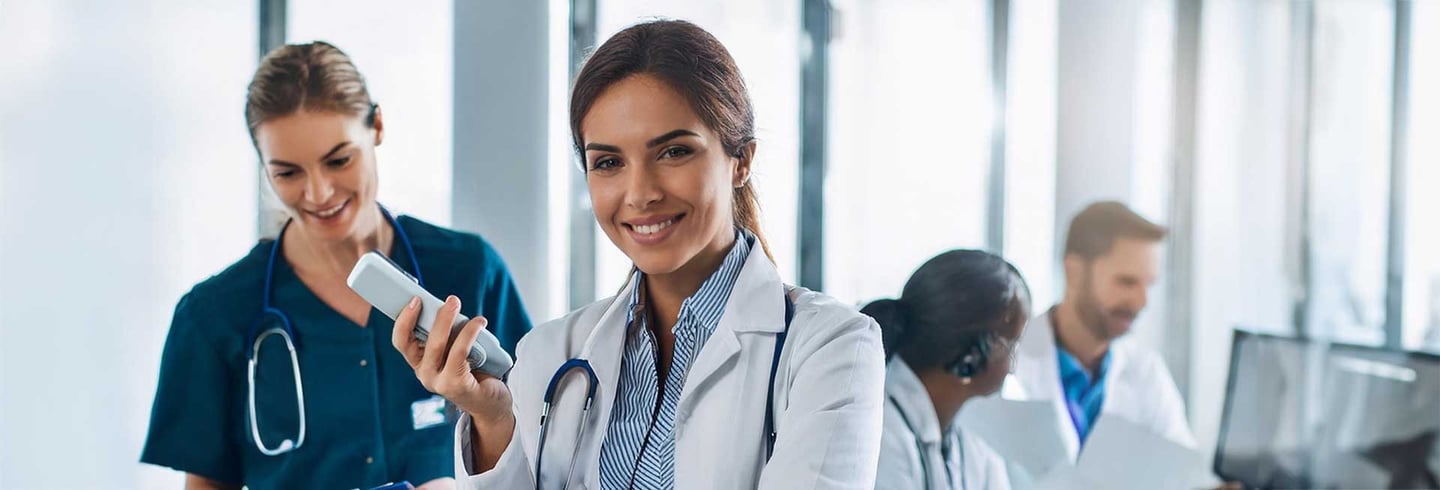 Doctor in a white coat and a nurse in a green scrub