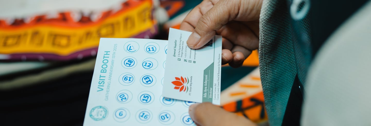 a person holding a piece of paper with a business card