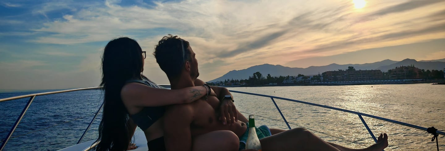 Couple enjoying sunset on a fairline targa yacht puerto banus marbella