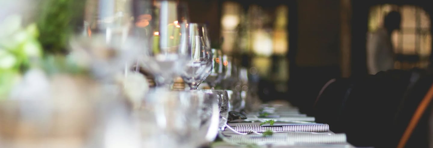 focused photo of wine glasses lined on table