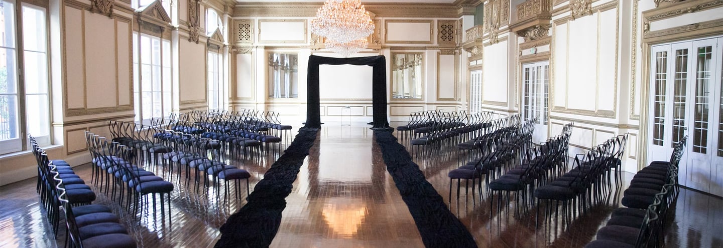 a long table with chairs and chairs in a room