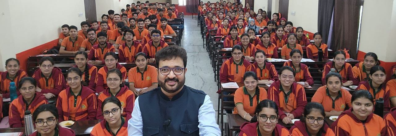 Mentor with a large group of students in a classroom setting.