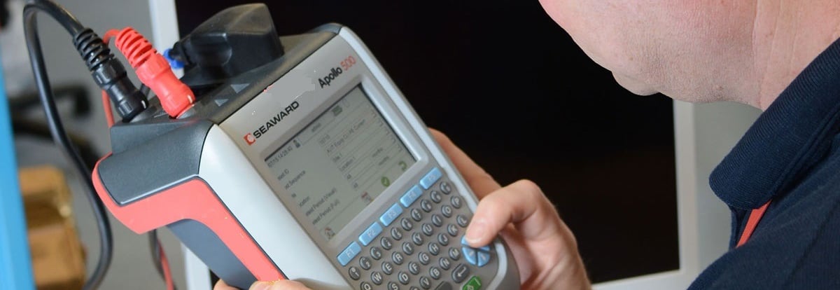 a man is holding a handheld computer