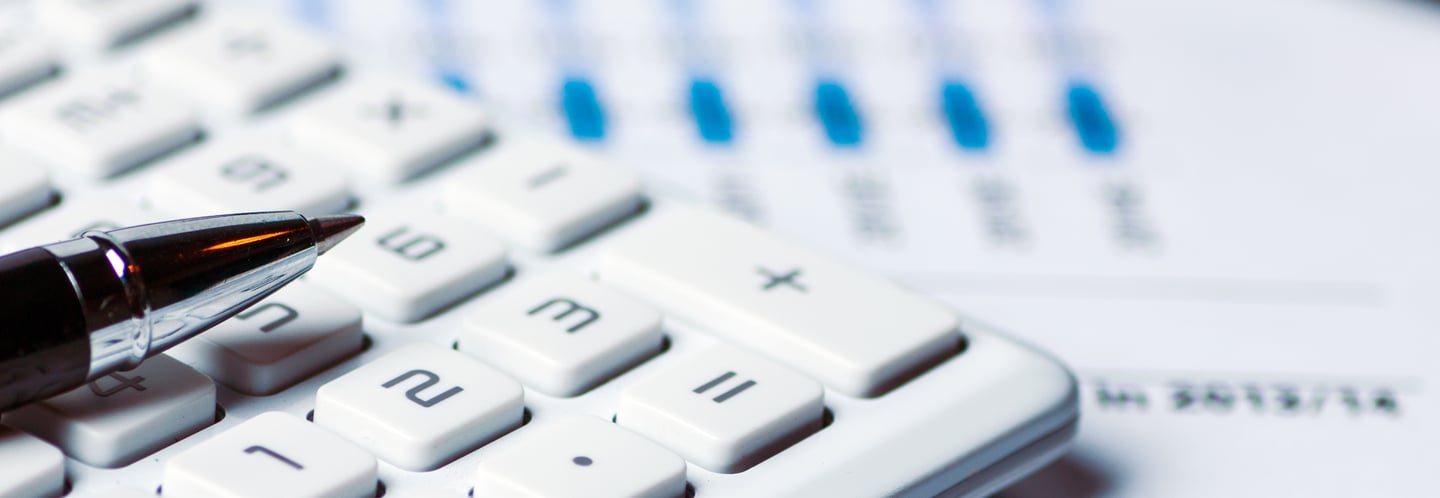calculator amidst stack of documents