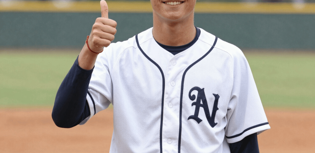 A welcoming hand extended in front of a community center at sunset.