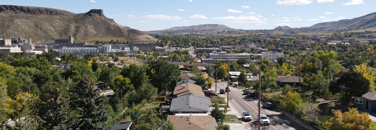 Drone shot of a neighborhood in Golden looking at Coors and South Table Mountain