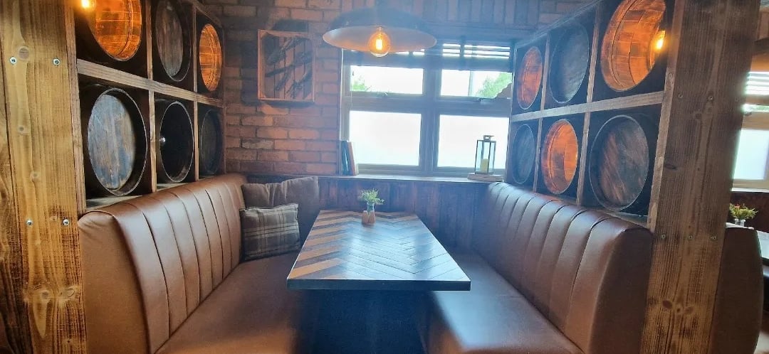 a couch with a table and chairs in a restaurant