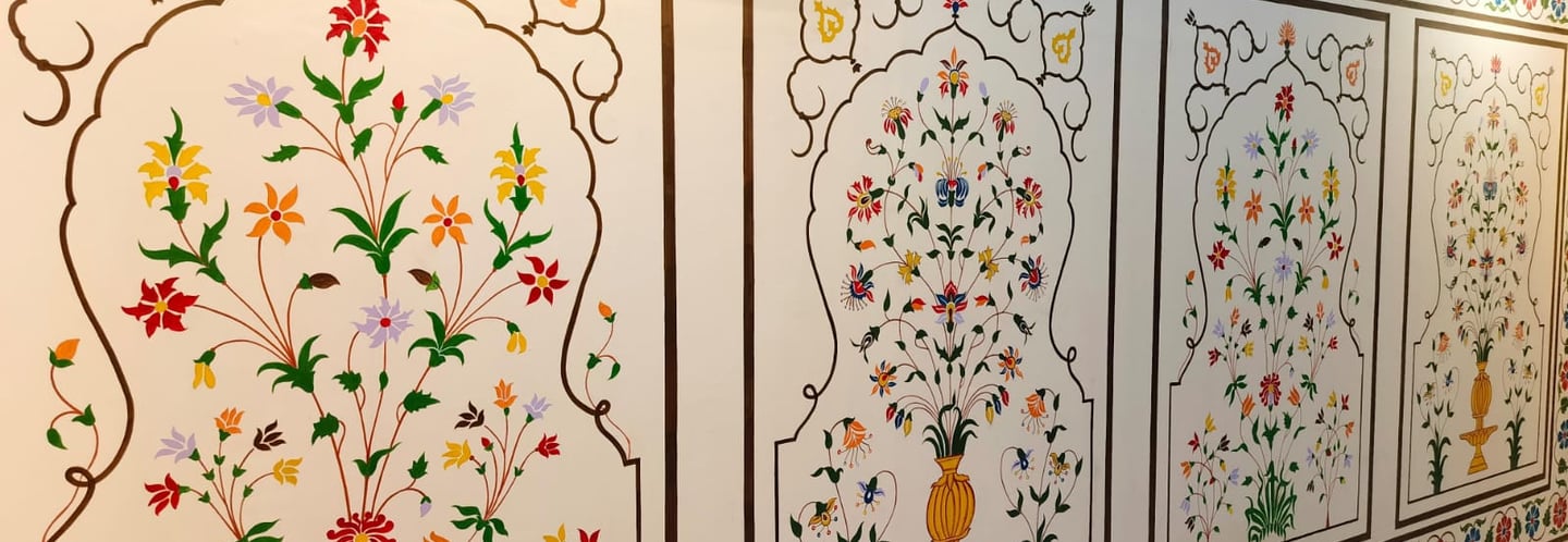 a wall with a wall art painting of flowers