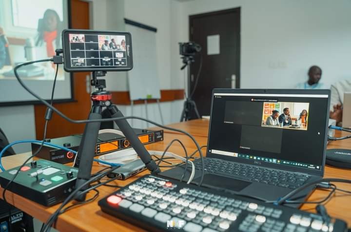 Professional live streaming setup featuring a laptop, video switcher, and monitor for a virtual conference.
