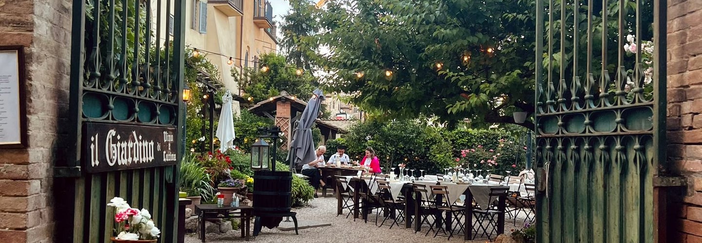 San Gemini, Il giardino - Vino e cucina - a gated in area with a barrel of wine