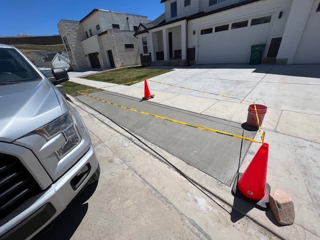 a truck parked in front of a house with a red cone