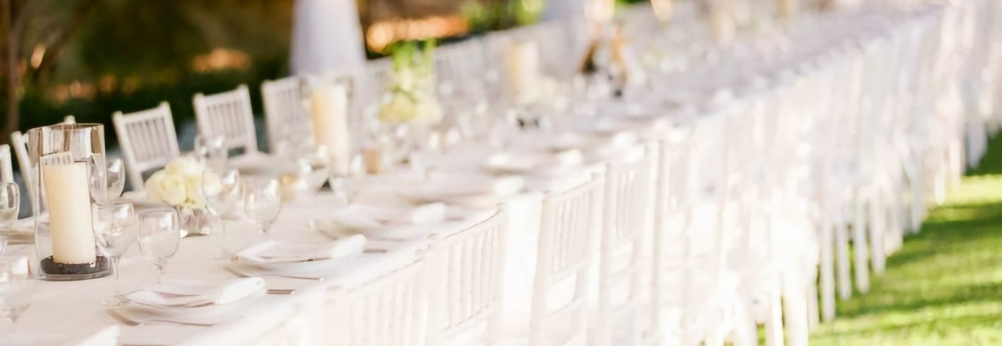 a long table with white chairs and tables