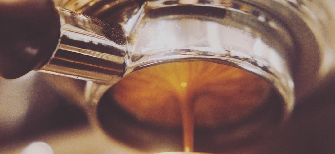 a coffee maker is making a cup of coffee