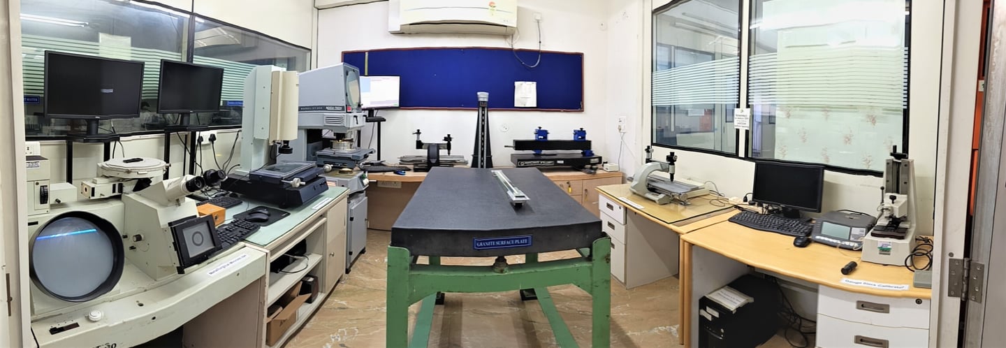 a room with a desk calibrated Industrial Instruments at NABL Certified LABand a computer monitor