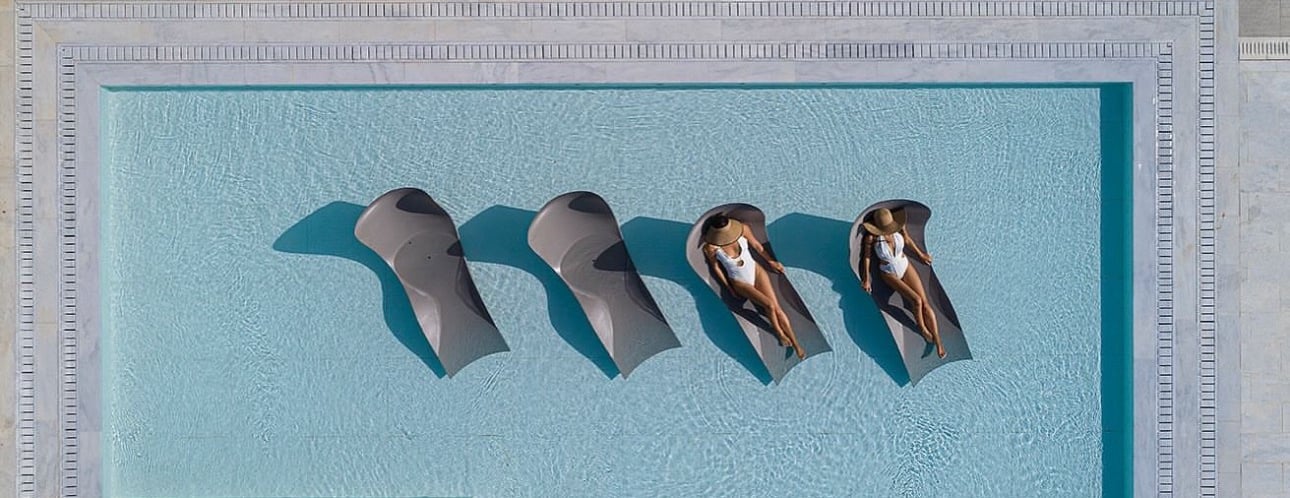 a couple of people sitting in a pool
