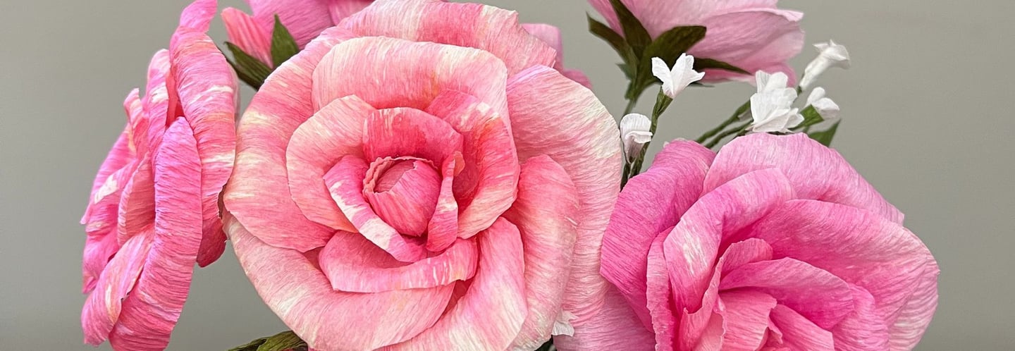 roses in various shades of pink hand-made from tinted crepe paper