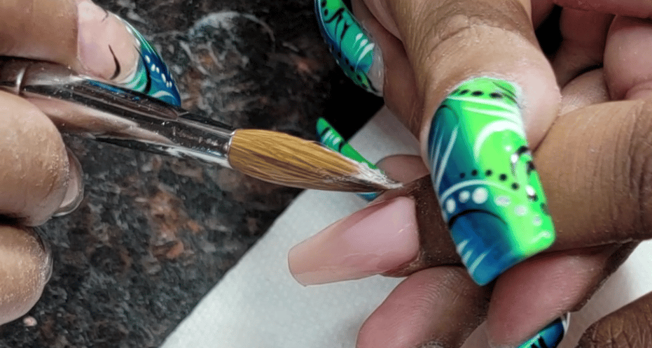 a person is doing a manicure with a brush and a brush