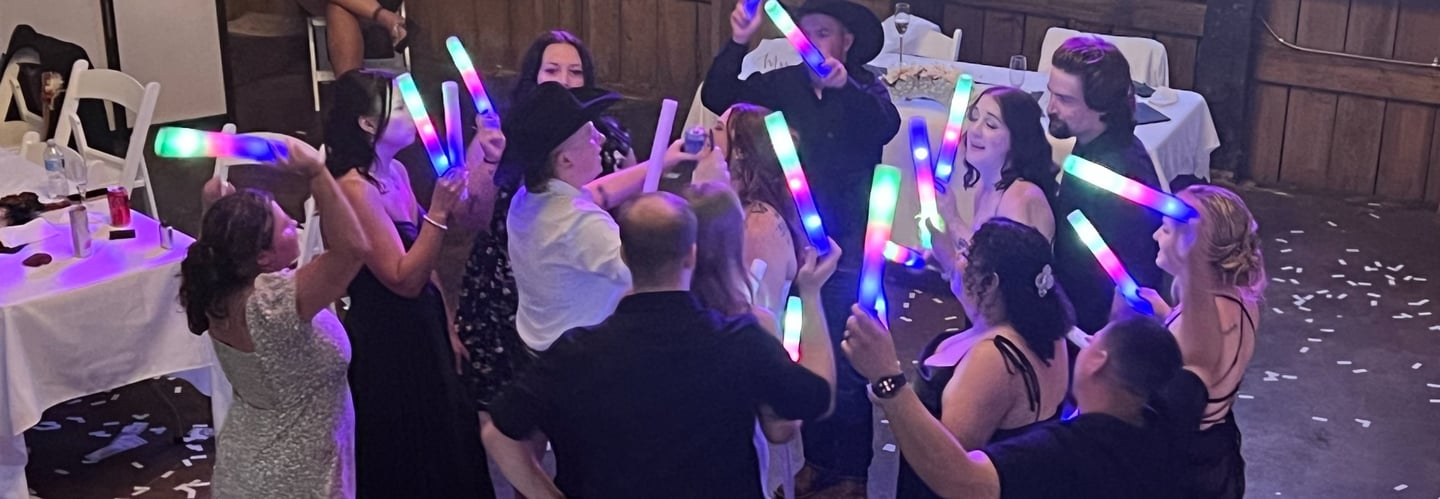 people dancing with lighted foam toys