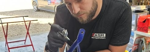 a man working on a kart frame