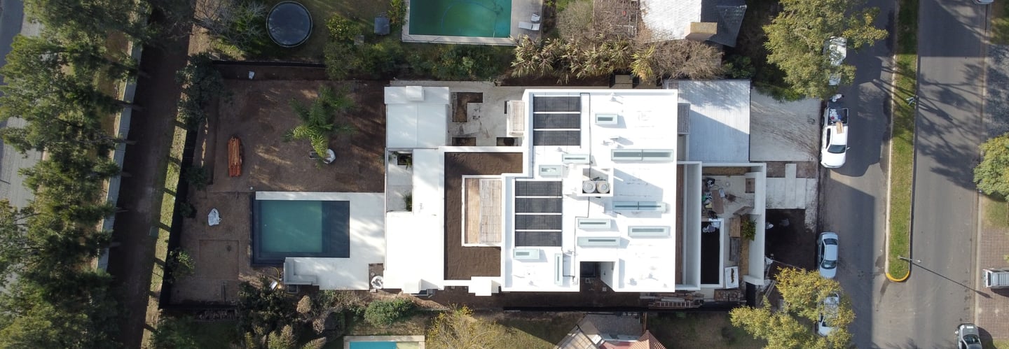 a house with a pool and a pool in the middle of a neighborhood