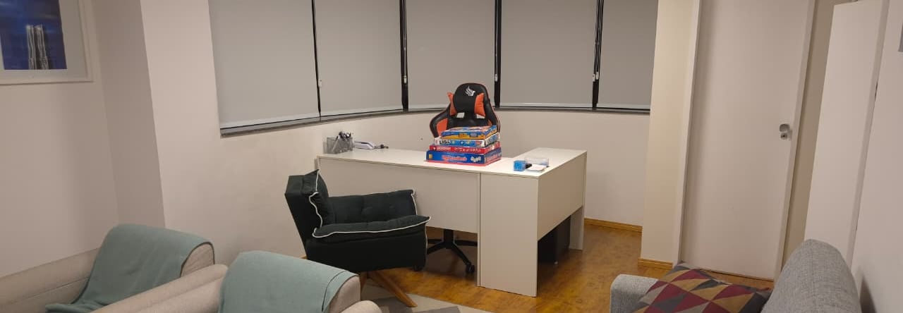 a desk with a desk and chairs in a room