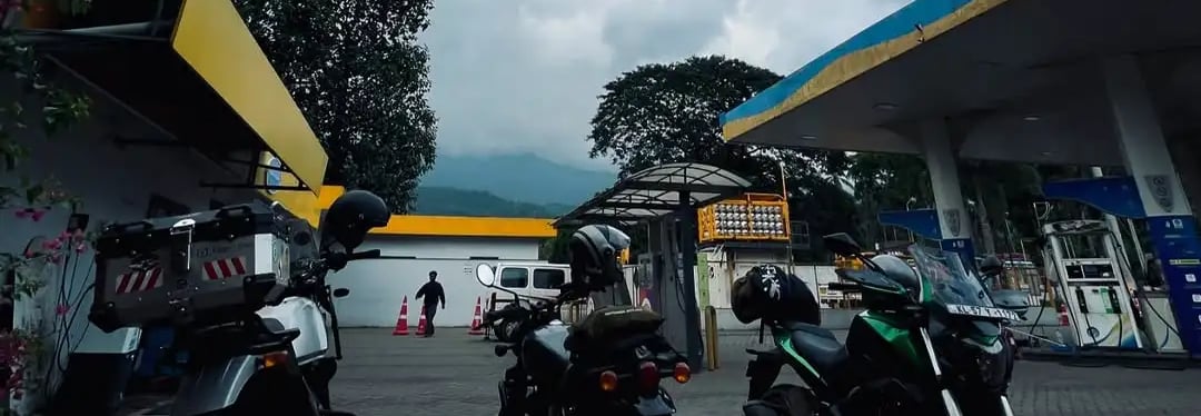 three bikes standing at fuel station
