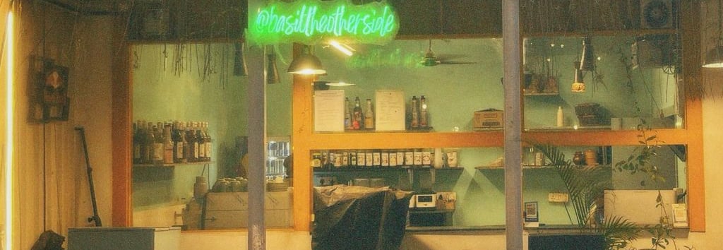 basil the otherside with a neon sign