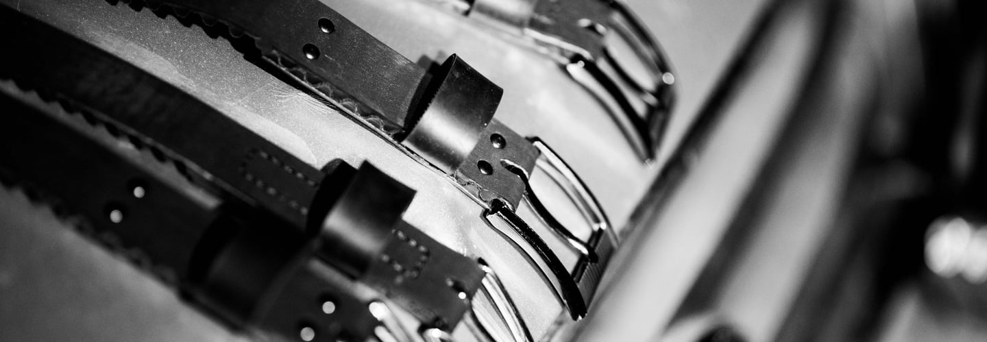 assortment of belts in black and white